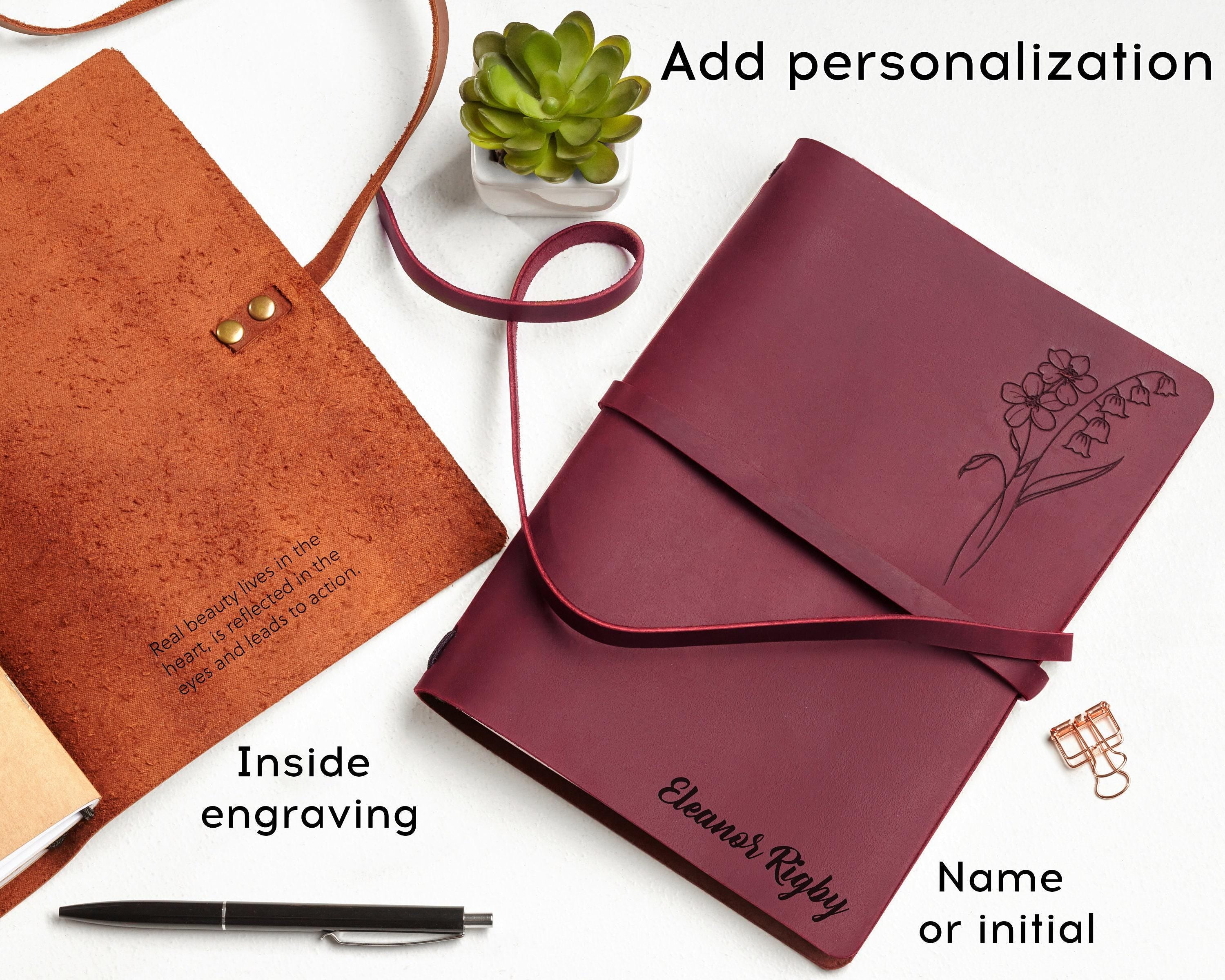 a personalized notebook and a pen on a table