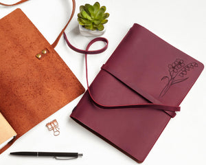 a notebook and a pen on a table